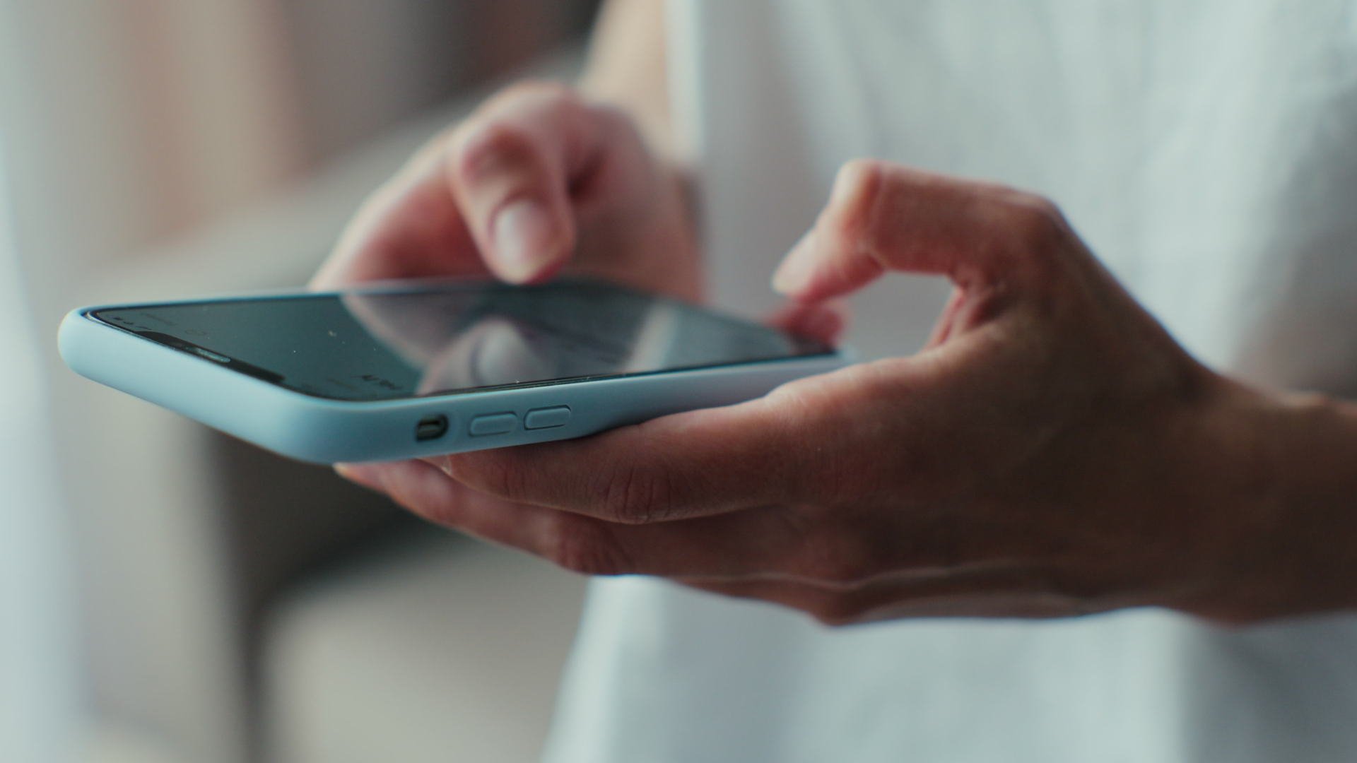 Close up of a person playing a business simulation on their phone